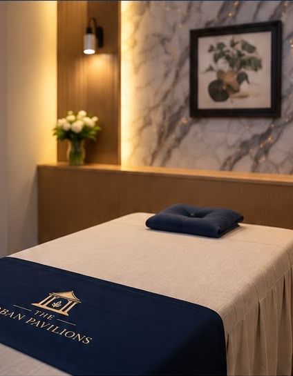 A private treatment room with a navy runner embroidered with The Urban Pavilions crest